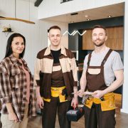 young-woman-and-two-plumbers-standing-in-living-ro-2023-11-27-05-02-13-utc (1)